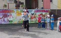 Scenario of summer entertainment with a cat leopold in a kindergarten on the street